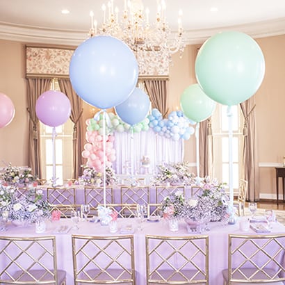big balloons over table for pastel princess birthday party